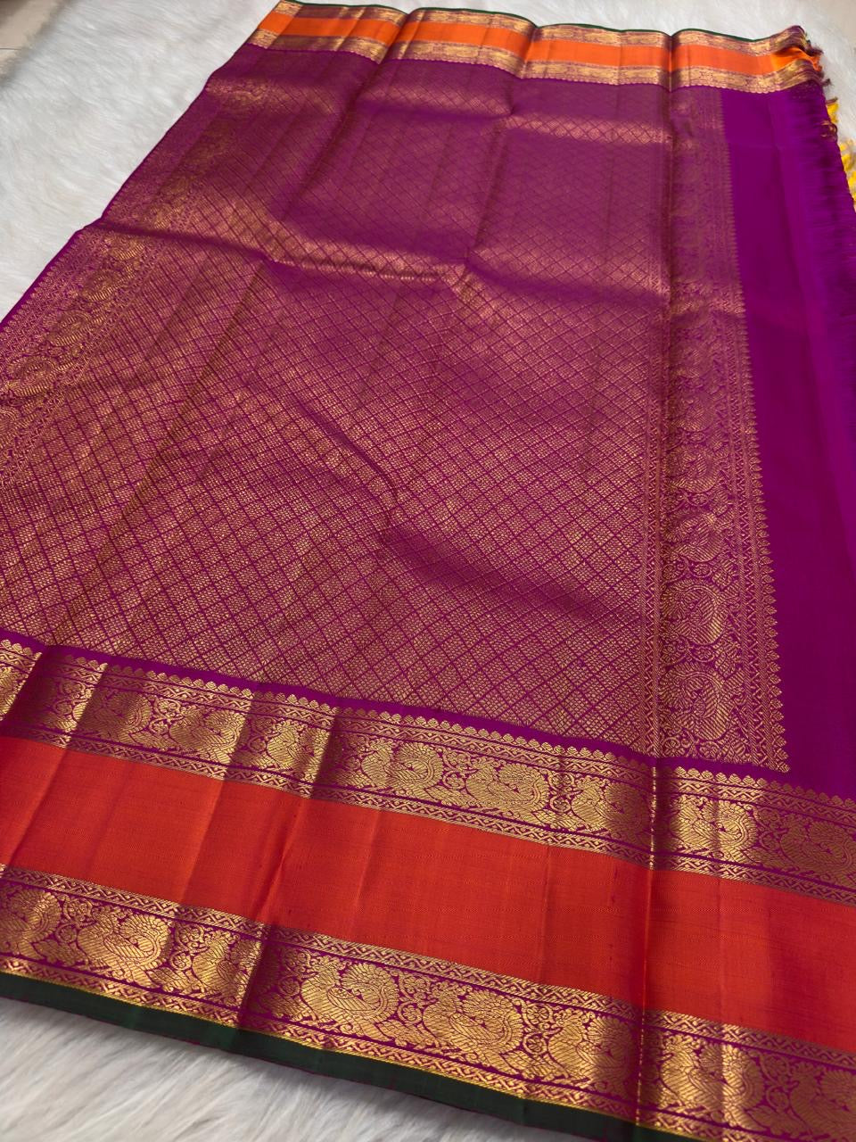 Handwoven sunflower-yellow Korvai Kancheepuram saree with saturated purple and coral contrast.