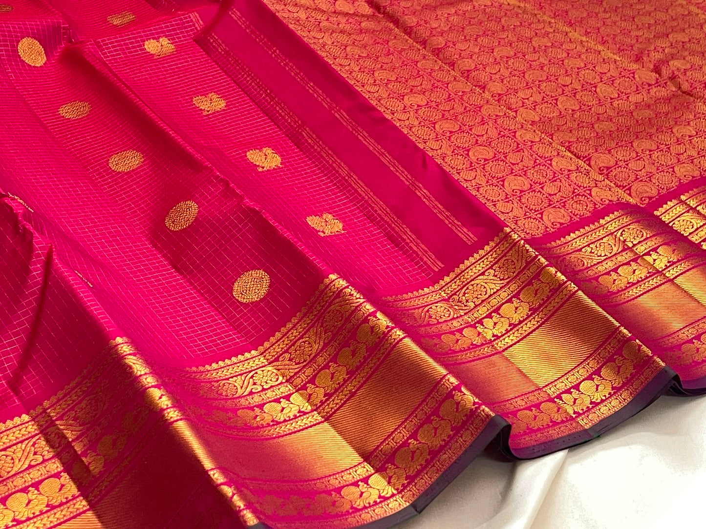 Handwoven Zari Kattam saree in fuchsia pink with Mayil Chakram motifs, styled view