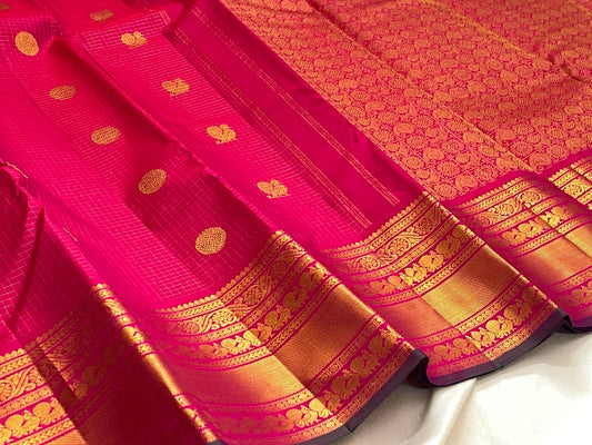 Handwoven Zari Kattam saree in fuchsia pink with Mayil Chakram motifs, styled view