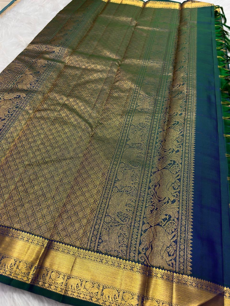 Handwoven Zari Kattam saree in royal teal blue with Mayil Chakram motifs, styled view