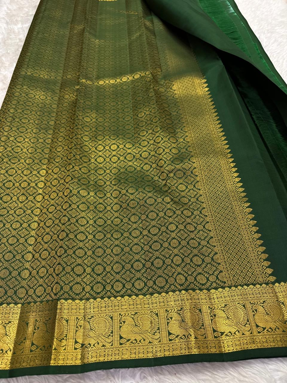 Large handwoven gold zari paisley butta on Deep Emerald Green Kanchipuram silk
