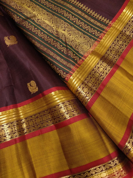Deep aubergine Kanjivaram silk saree with ruby selvedge and traditional gold zari work
