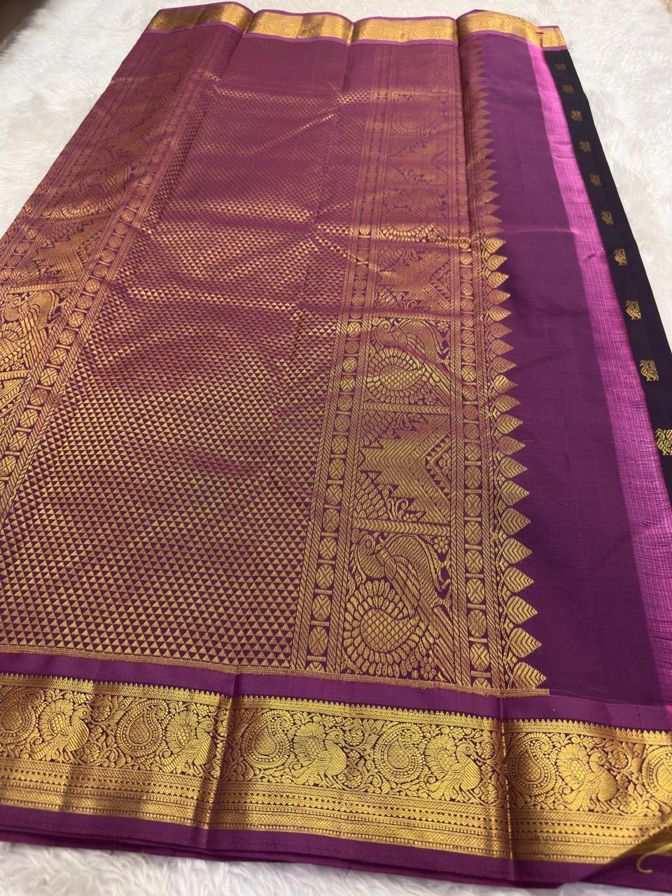 Purple Kancheepuram silk saree with richly woven traditional mayil border
