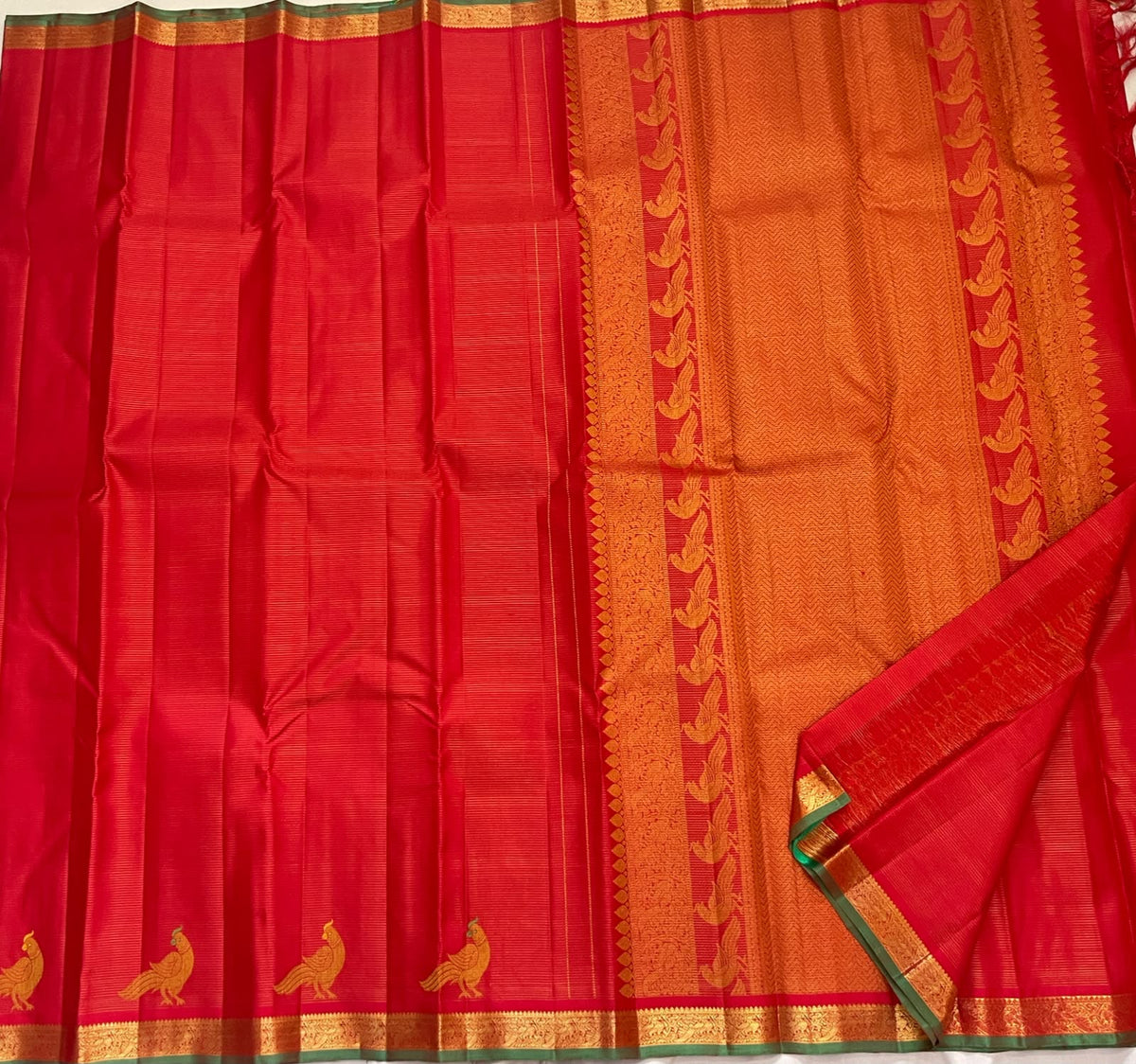 Handwoven vermilion red pure silk Kanchipuram saree with gold floral zari borders and Kili parrot row