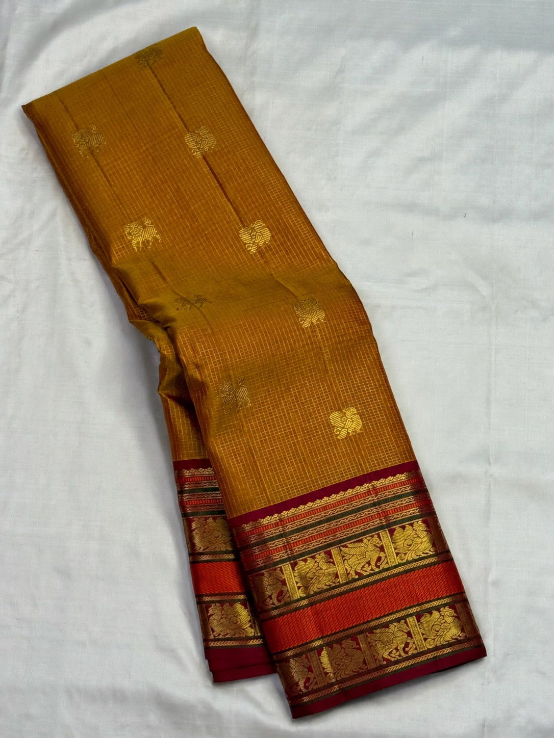 Pure silk Kanchipuram saree in Honey Brown with Arakku Red, traditional handwoven border and zari detail