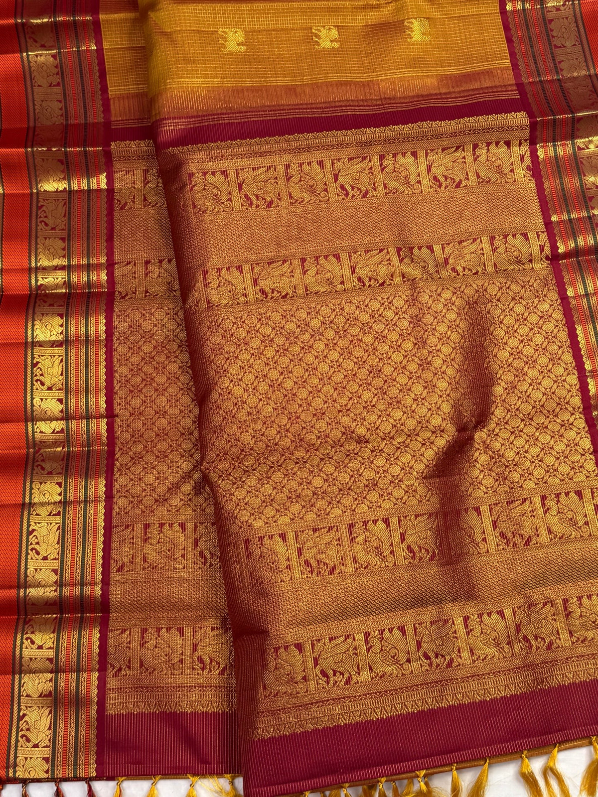 Honey Brown Zari Kattam saree with alternating Mayil and Yazhi gold motifs and layered Arakku Red border