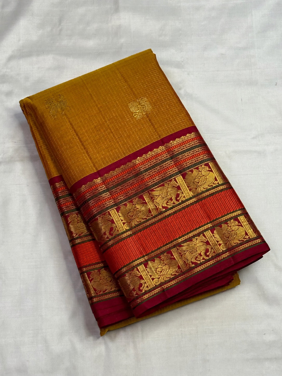 Honey Brown with Arakku Red Kanchipuram silk saree with the body details of its Zari Kattam design