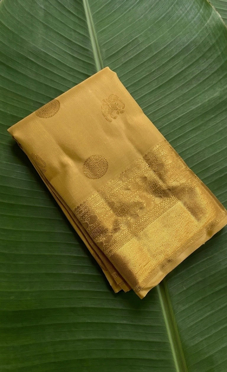 Kanchipuram silk saree in honey gold with antique gold border Mayil Butta weave folded view