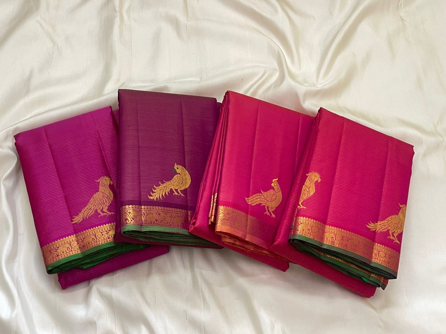 Ornate parrot Kili Butta gold zari pallu of hot pink KanchiPattu saree on copper ground