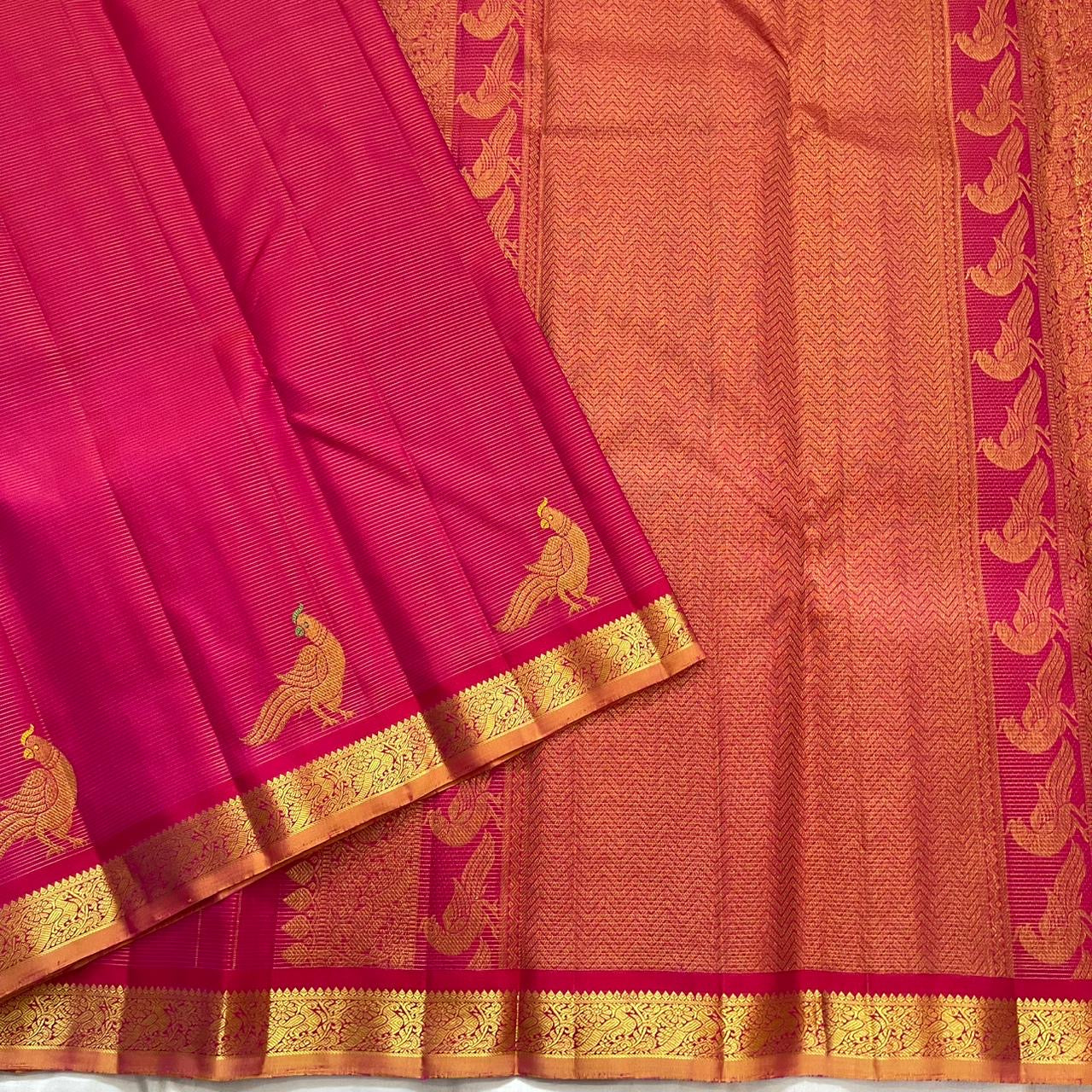 Close view of hot pink KanchiPattu silk body with fine Vairaoosi zari lines running horizontally across the field