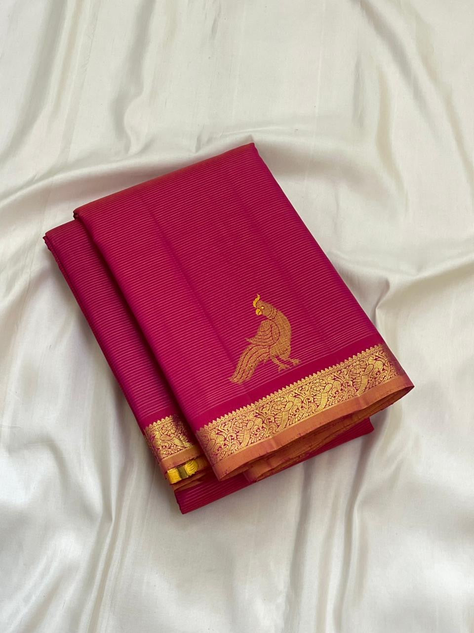 Detail of fine Vairaoosi zari lines woven continuously across hot pink KanchiPattu pure silk body