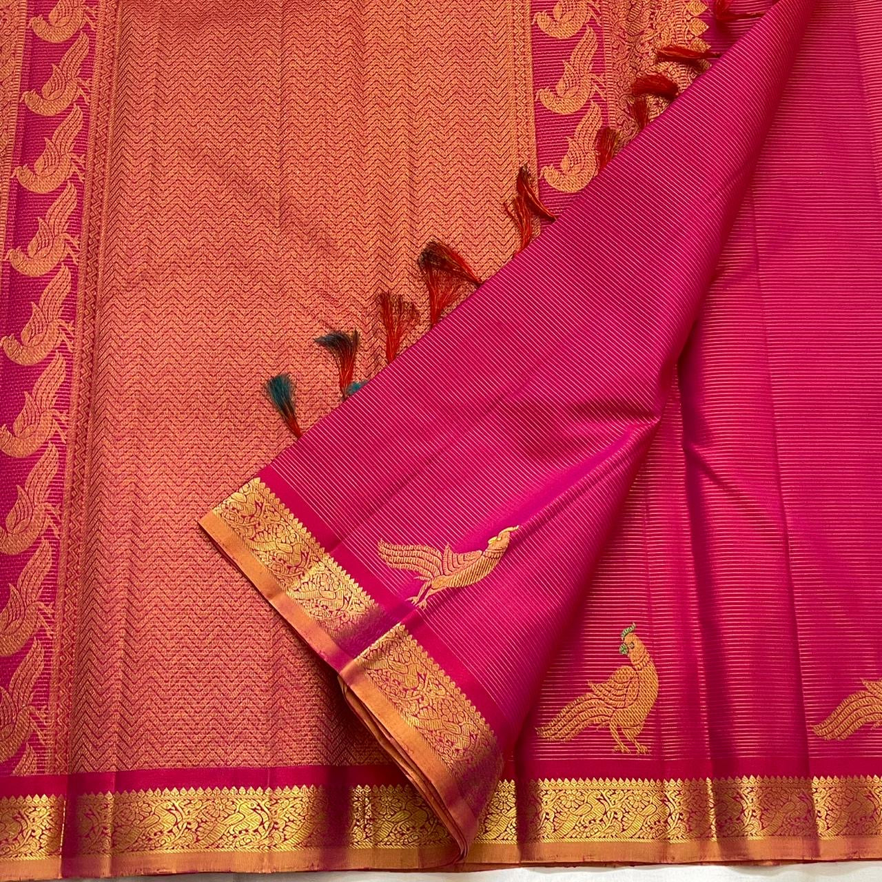 Handwoven hot pink KanchiPattu pure silk saree with fine Vairaoosi zari shimmer body and contrast copper border