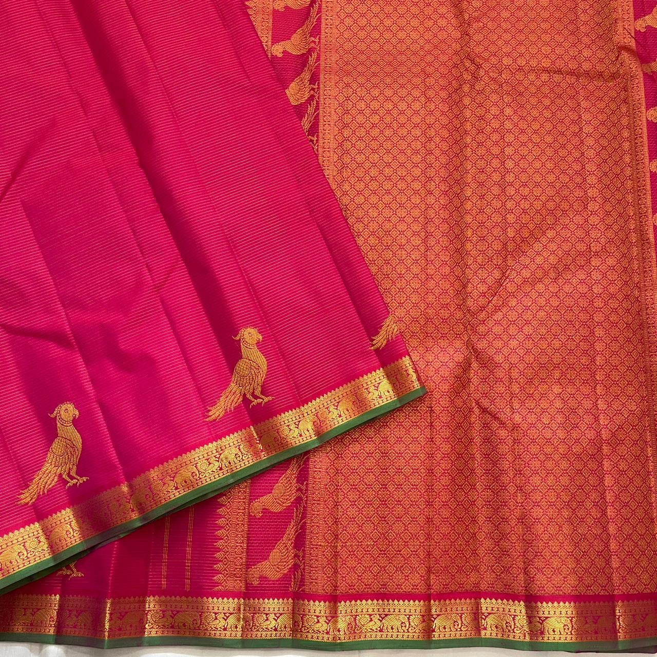 Forest green gold zari border of hot pink Kanchipuram pure silk saree with classical temple motif frieze