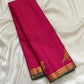 Close view of hot pink Kanchipuram silk body with fine Vairaoosi zari lines running horizontally across the field