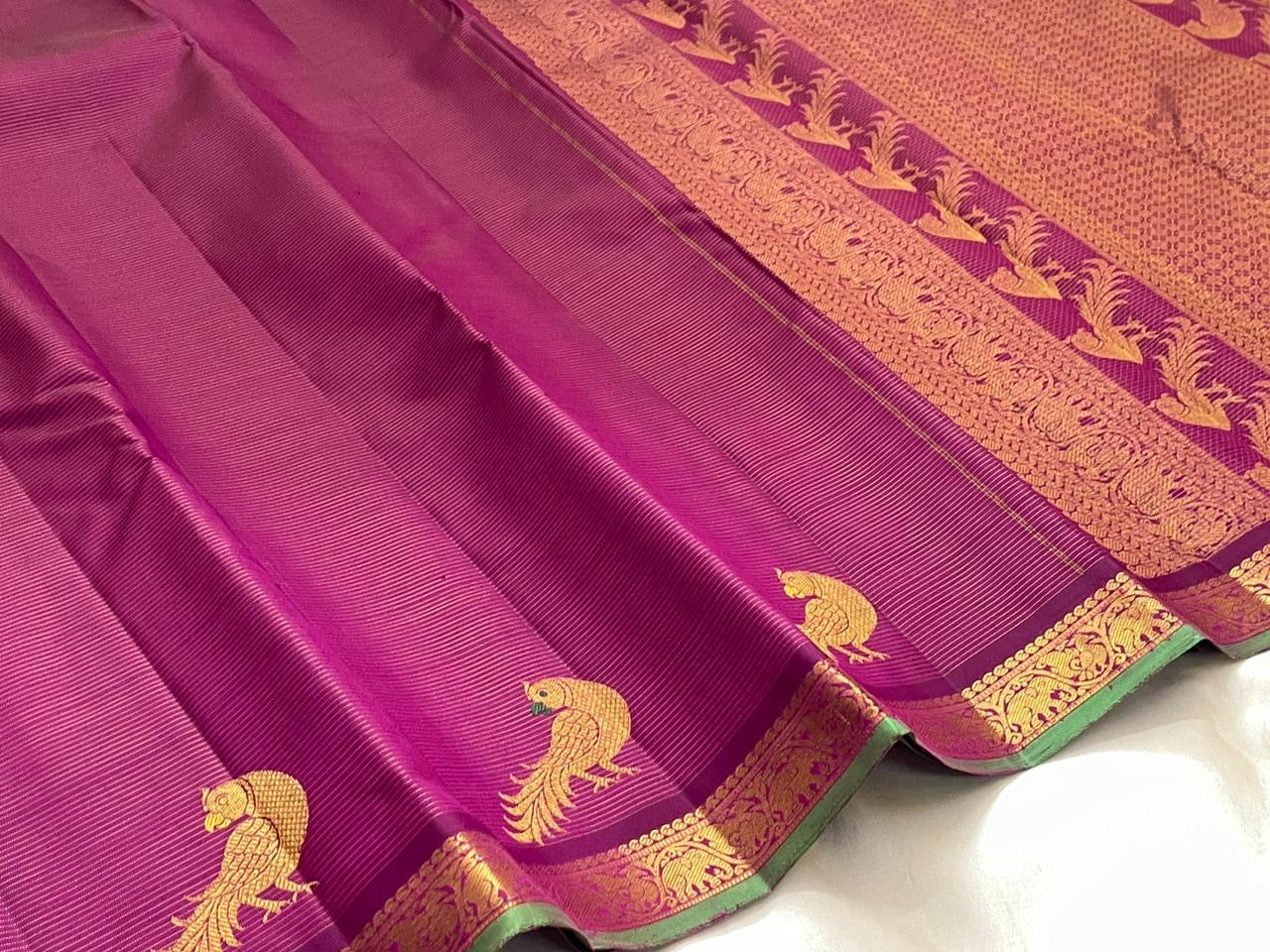 Forest green gold zari border of hot pink Kanjipuram pure silk saree with classical temple motif frieze