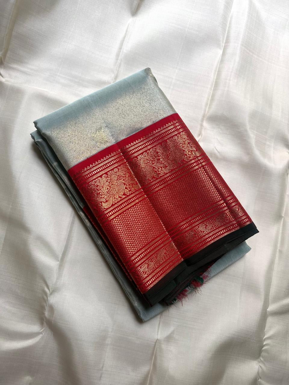 Ice blue tissue Kanchipuram silk saree with Korvai red zari border