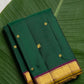 Deep emerald green Kanchipuram pure silk saree with floral butta and antique gold border – Idam Living