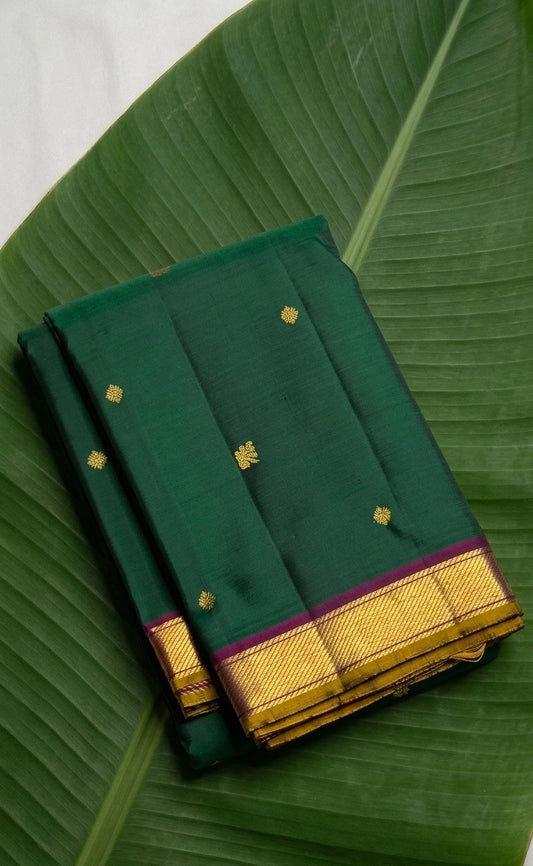 Deep emerald green Kanchipuram pure silk saree with floral butta and antique gold border – Idam Living
