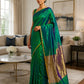 Emerald green and royal blue pure silk Chanderi handloom saree with traditional gold zari border styled in a luxury white panel wall New Jersey living room