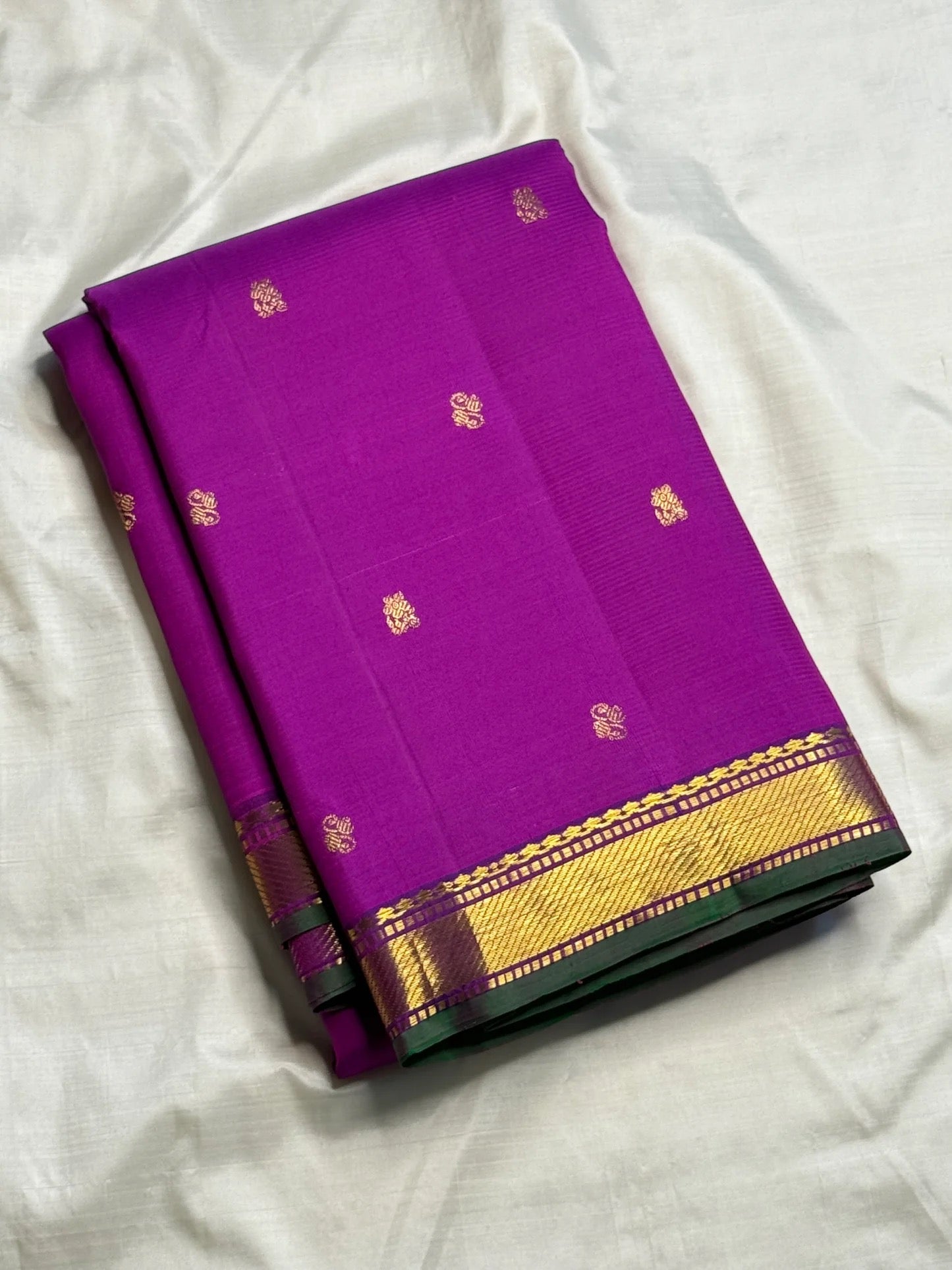 Pure Kanchipattu silk saree in royal orchid purple with ornamental floral motifs and traditional zari craftsmanship