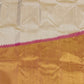 Close view of pink temple border on cream Kanchipuram silk saree with antique gold zari