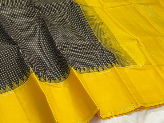 1. Pure Kanchipuram silk saree deep green body with vibrant yellow border kanchi kattam checks folded view