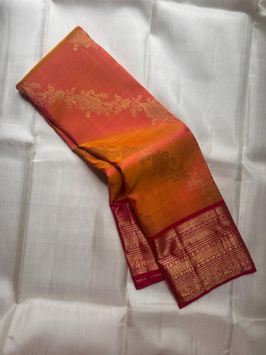 Pure Kanchipuram silk saree in sunset orange featuring traditional kodi butta motifs woven with gold zari