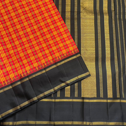 Orange red Pure Kanchipuram silk saree featuring structured kanchi kattam grid pattern with dark contrast border and gold zari detailing