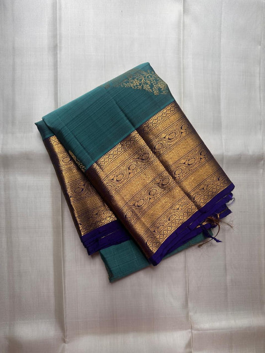 Pure Kanchipuram silk saree in cerulean blue featuring traditional kodi butta motifs with royal blue border woven in gold zari