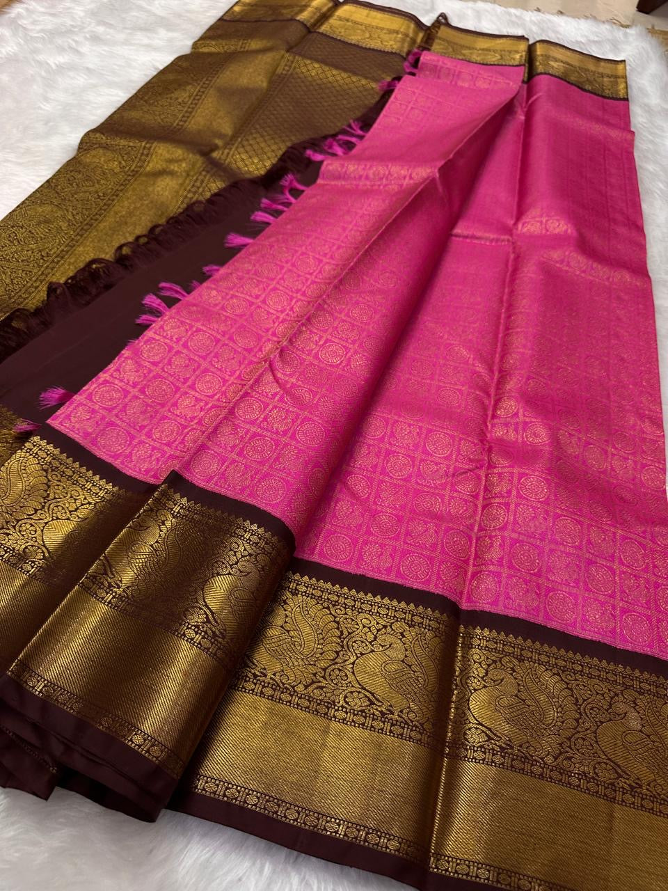 Saree with pink and brown colors on a white background