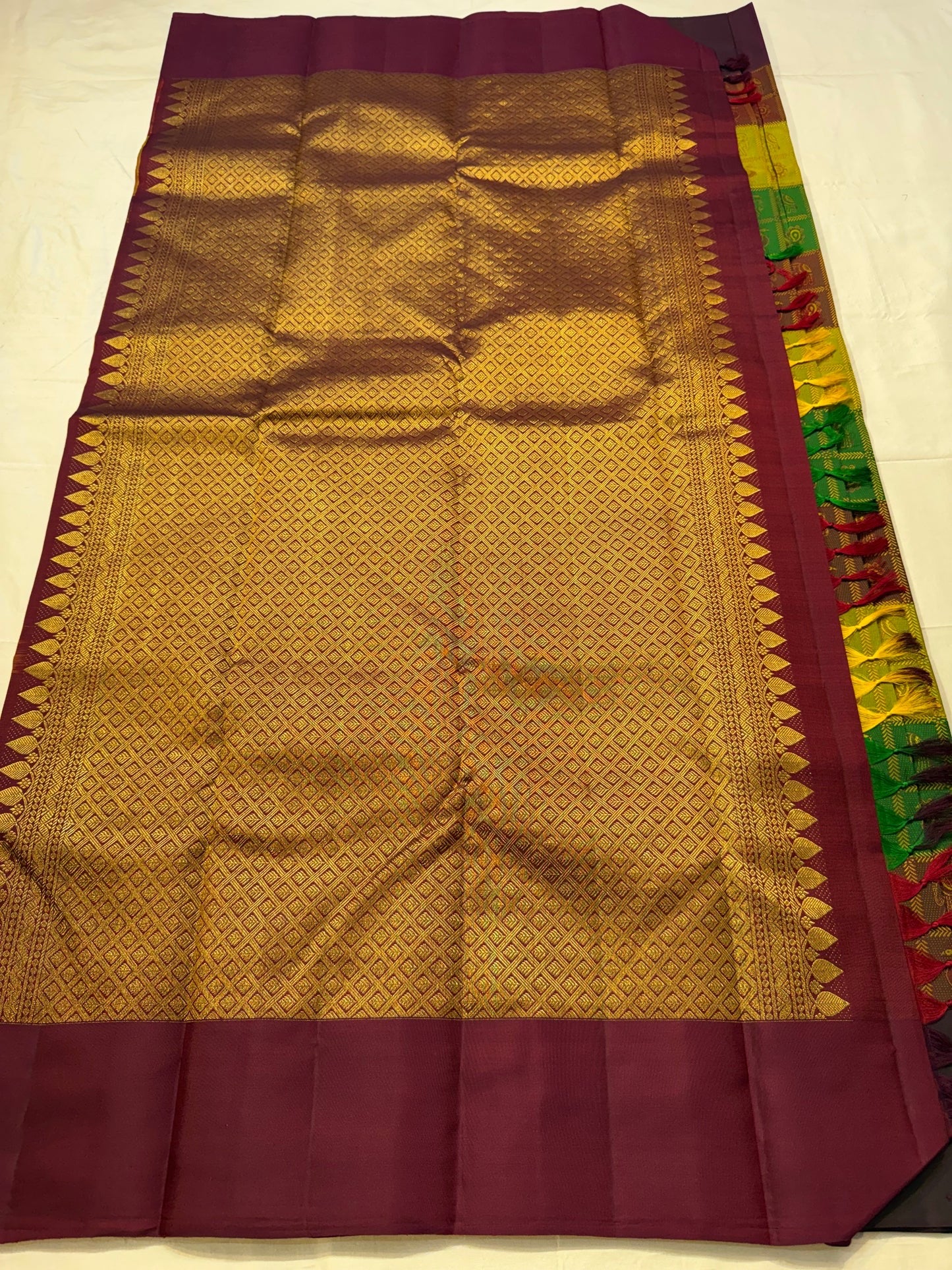 Mulberry plum motif border detail on forest green Kanchipattu silk saree Idam Living