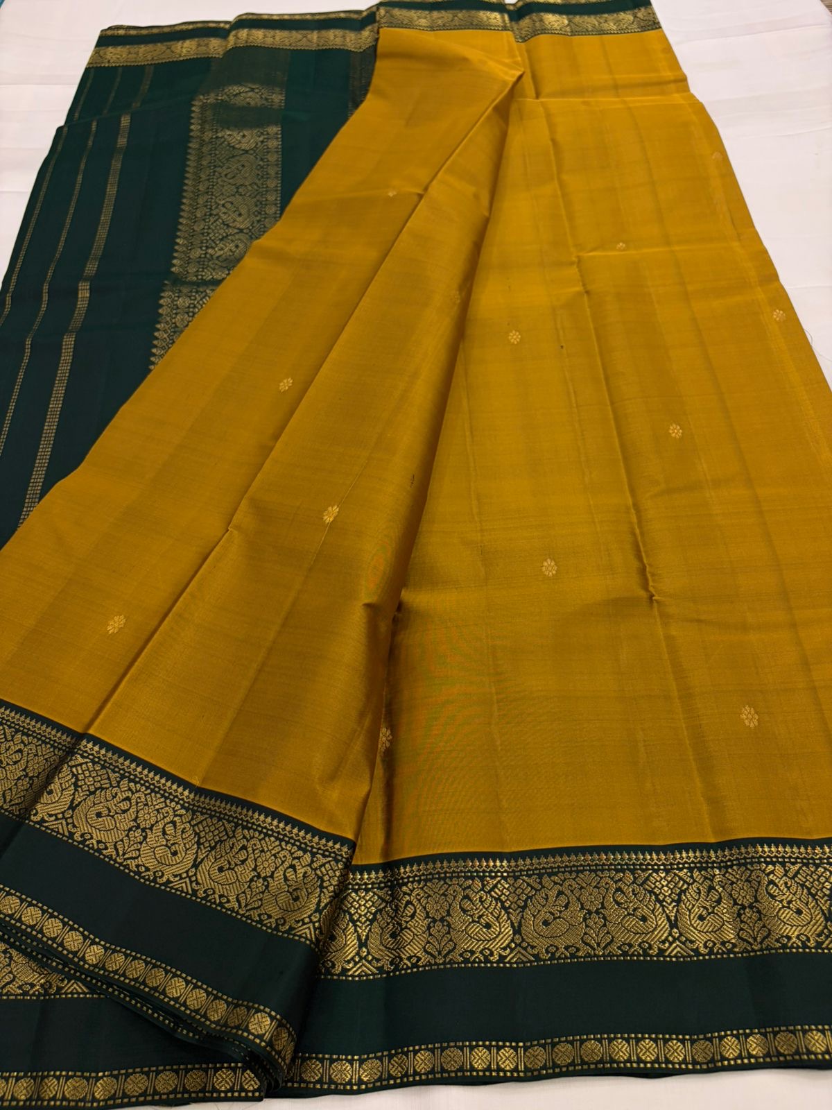 Mustard and Dark Green Handwoven Pure Silk Kanchipuram Saree with Zari Peacock Border.