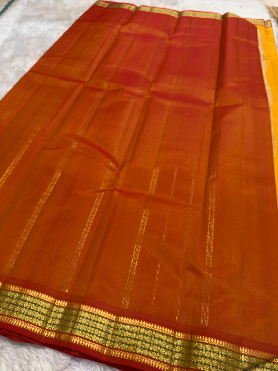 Mustard and Rust Handwoven Pure Silk Kanchipuram Saree with Gold Zari Band Border.