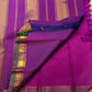 Traditional Kanchi Pattu silk saree with floral buttas, emerald green zari border, and richly woven seer pallu