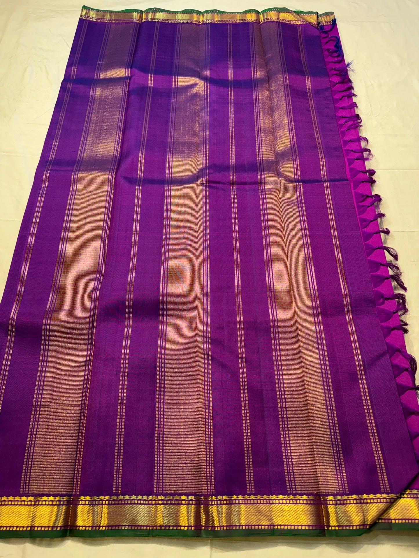 Royal orchid purple Kanjeevaram silk saree with emerald green contrast border and classic handwoven detailing