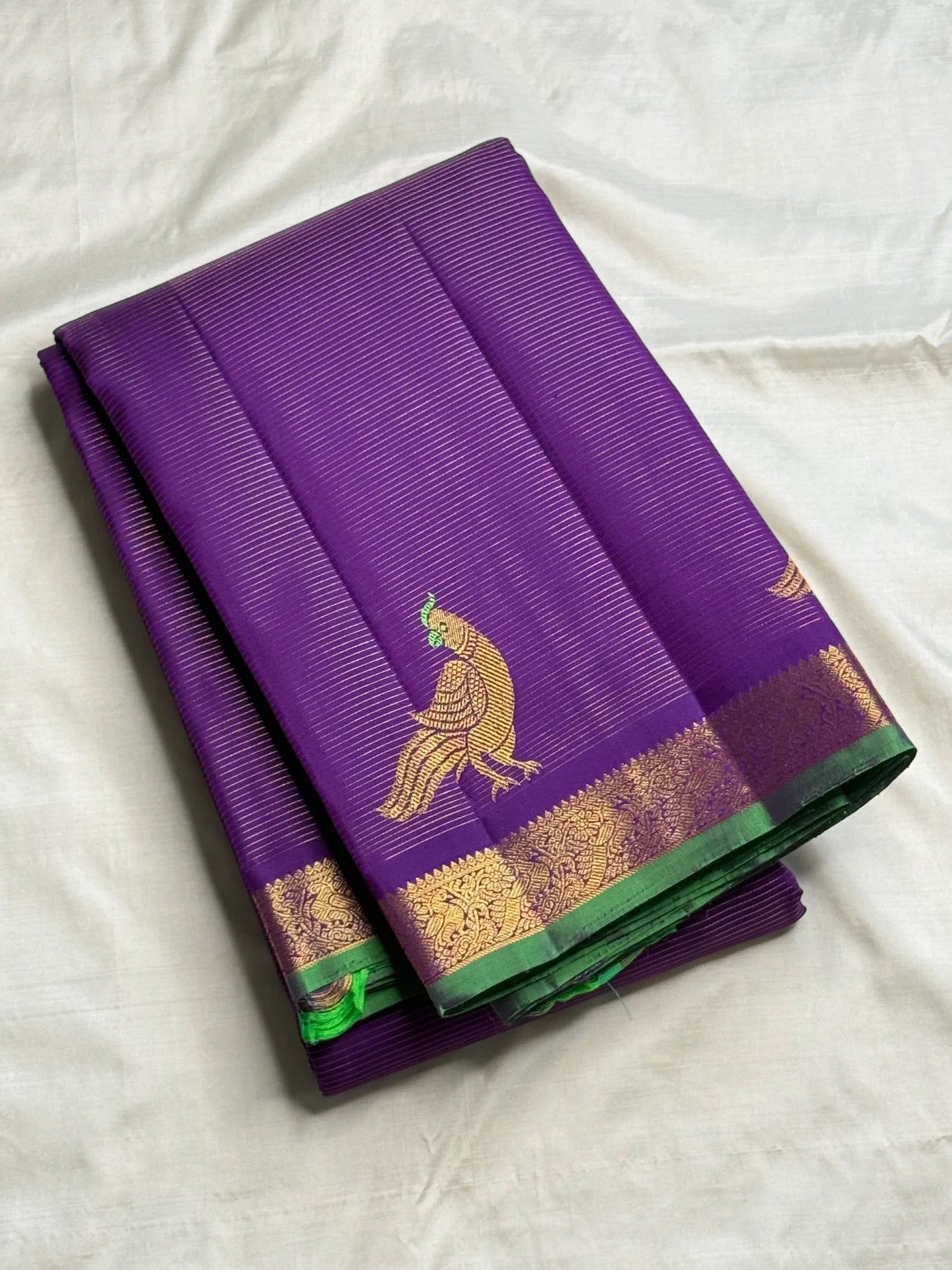 Royal Violet Kanjipuram silk saree showing fresh green selvedge detail