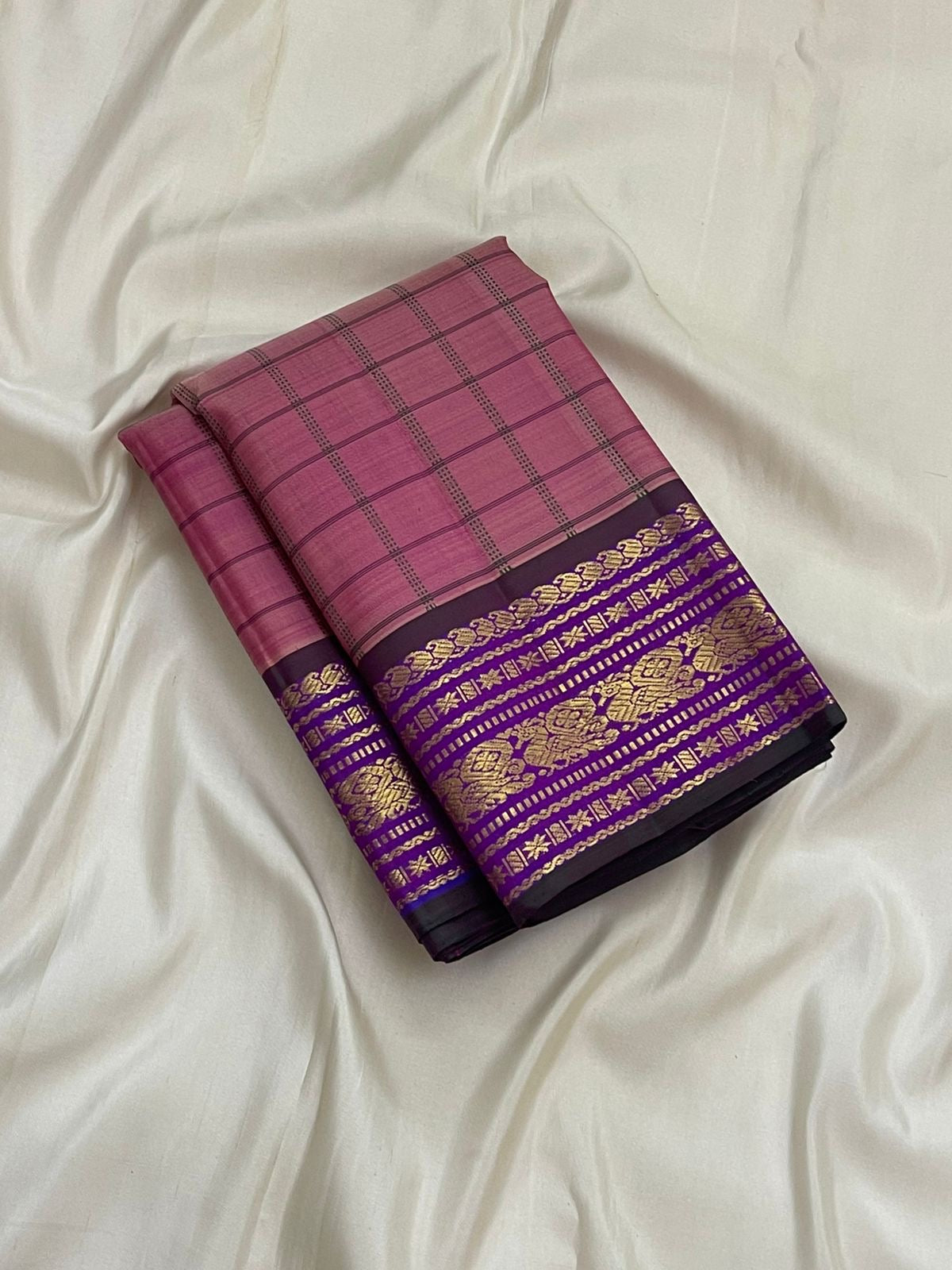 1. Pure Kanchipuram silk saree pink body with orchid purple border kanchi kattam checks folded view