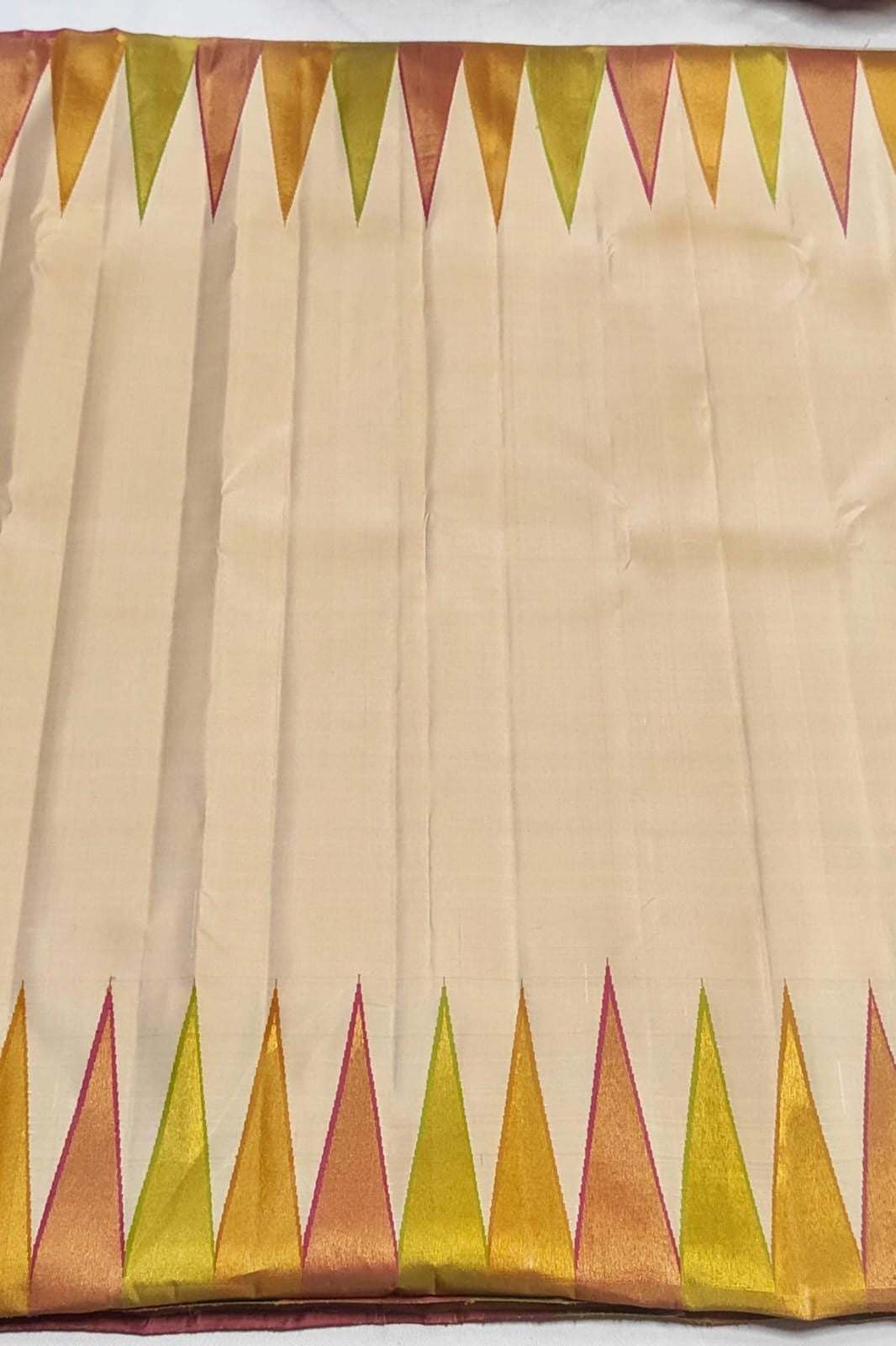 Pure silk Kanchipuram saree in ivory featuring ettukol weave with temple geometry border and gold zari pallu