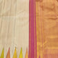 Traditional ivory Kanchipuram silk saree in ettukol weave with vibrant temple border and antique gold zari