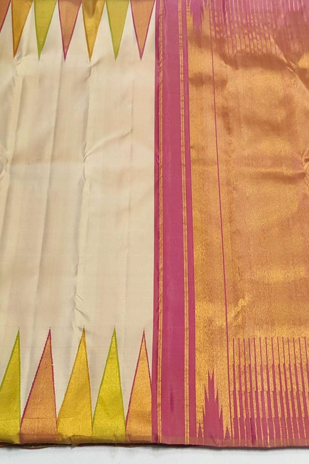 Traditional ivory Kanchipuram silk saree in ettukol weave with vibrant temple border and antique gold zari