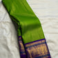 Close view of antique-gold ornamental weaving on the Royal Purple Korvai border.