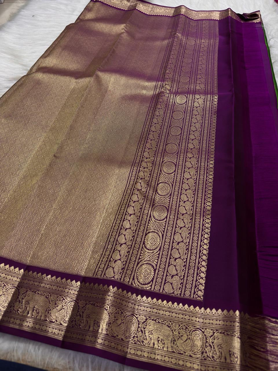Vadamalli Purple contrast Kanjivaram border with antique-gold elephant motifs.