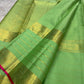 Leaf green Kanchipuram silk saree with spaced antique-gold zari buttas.