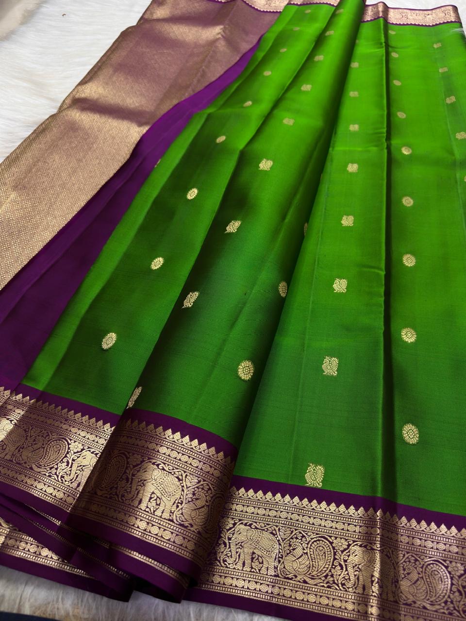 Green pure silk Butta saree with Vadamalli Purple elephant motif border.
