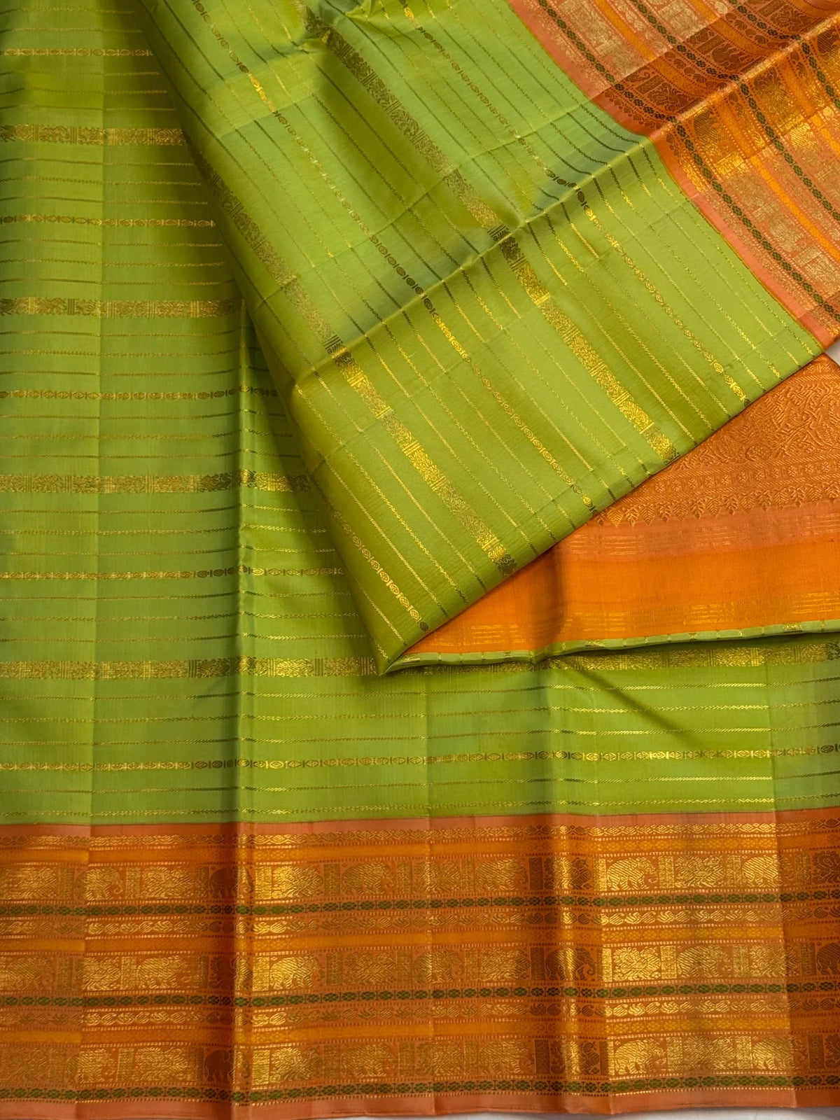 Handwoven ilampachai Pure Silk Kanchipuram Vairaoosi saree with soft green body and peach-gold contrast.
