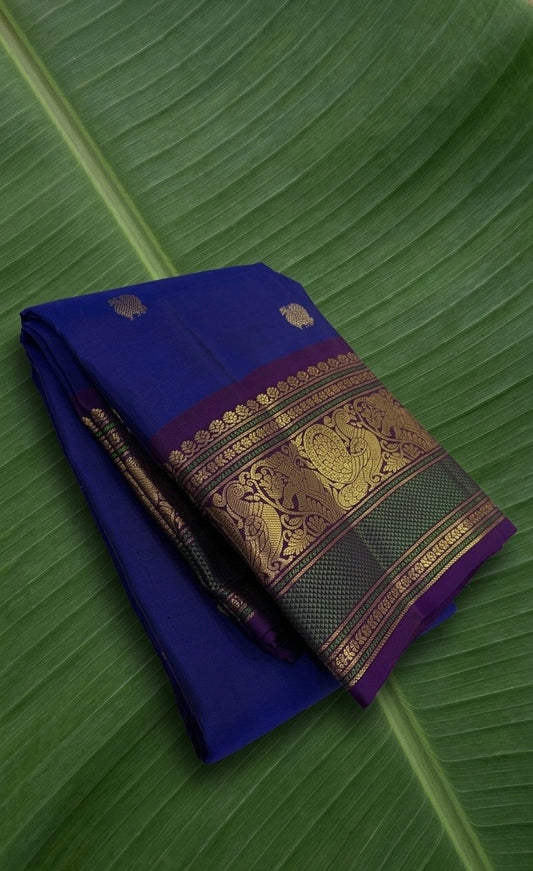 Imperial sapphire Kanchipuram silk saree with mayil butta motifs and korvai border.