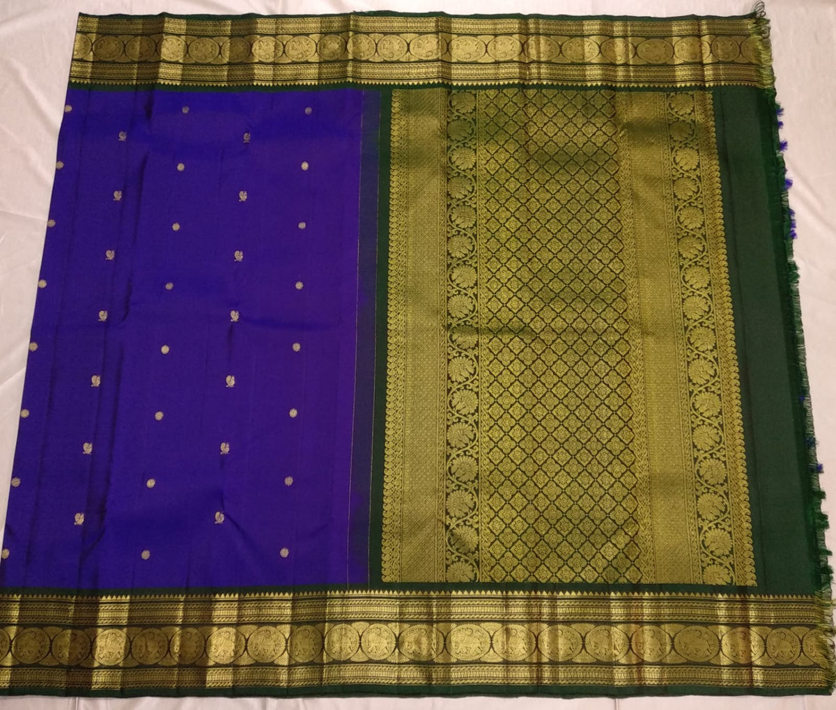 Close view of blue shot indigo silk body with small woven Mayil and Kamalam buttas