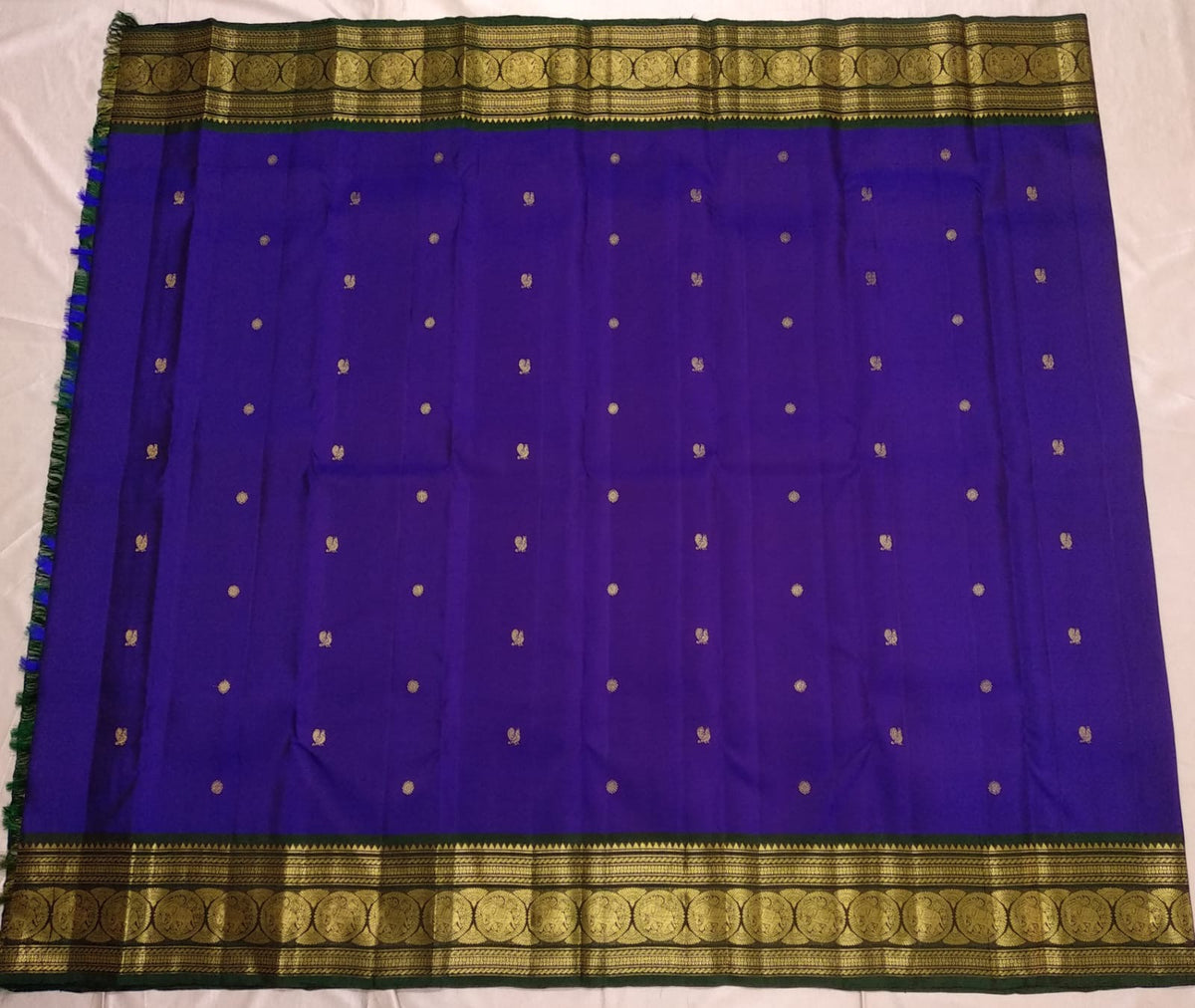 Deep indigo Pure Silk Kanchipuram saree with bottle green zari border and rich pallu detail