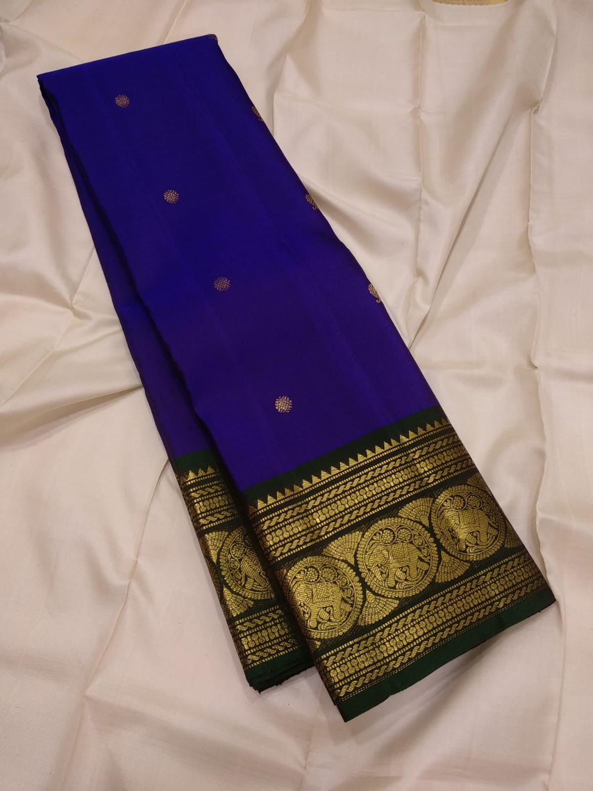 Zari detail of the ornate border and pallu on indigo and bottle green silk saree