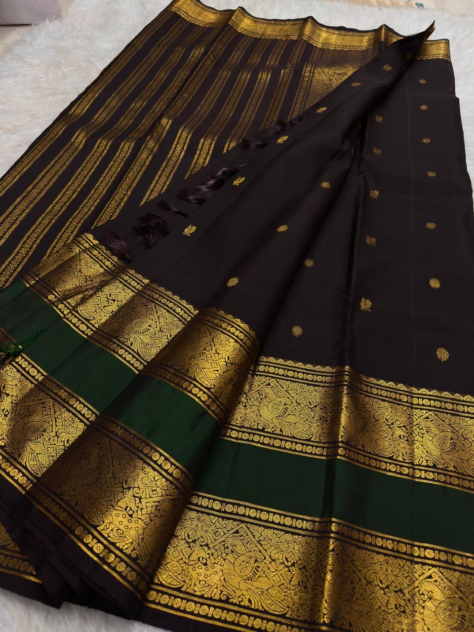 Angled display of deep brown × bottle green handwoven Rettapet Kanchipuram silk with gold zari bands and Mayil Chakram buttas